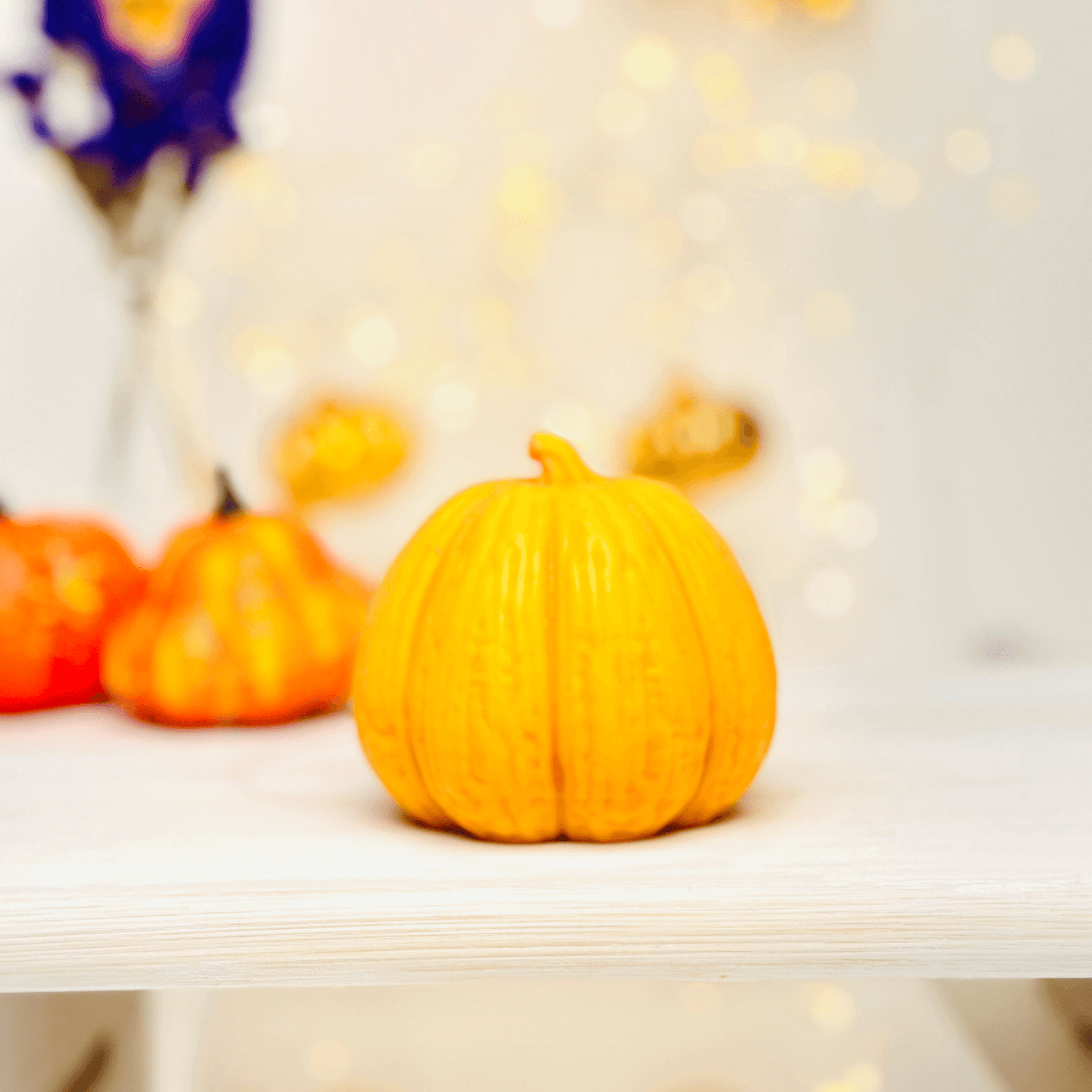 Vibrant orange pumpkin decoration on a wooden surface, perfect for Halloween celebrations.