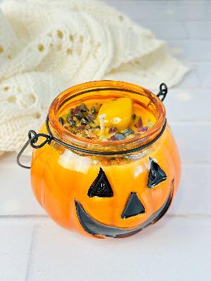 Hot Apple Pie scented soy candle in a glass Jack O' Lantern jar, perfect for Halloween decor and cozy ambiance.