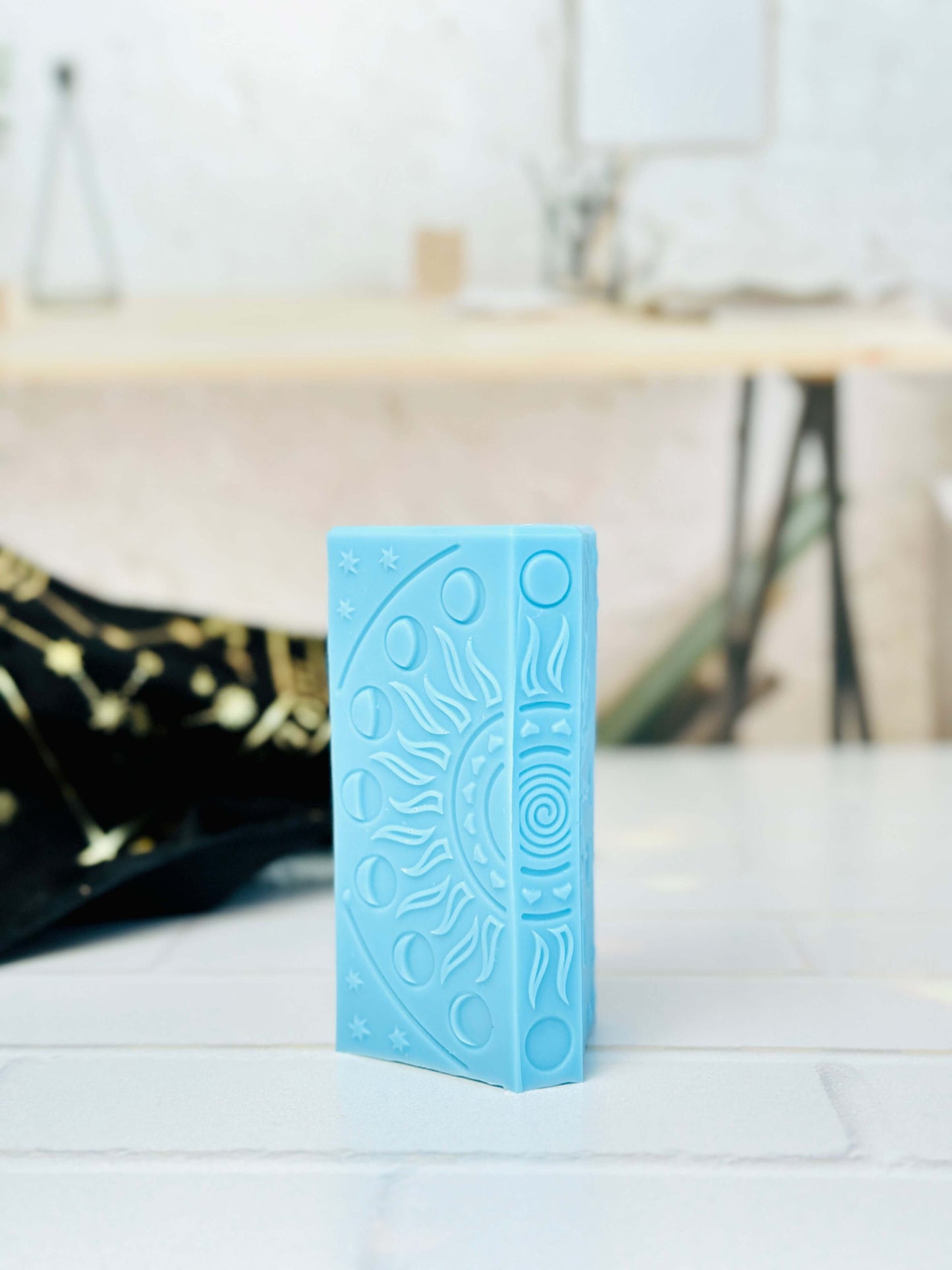 Blue silicone Emperor tarot card candle mold with moon phases, ideal for crafting spiritual candles.