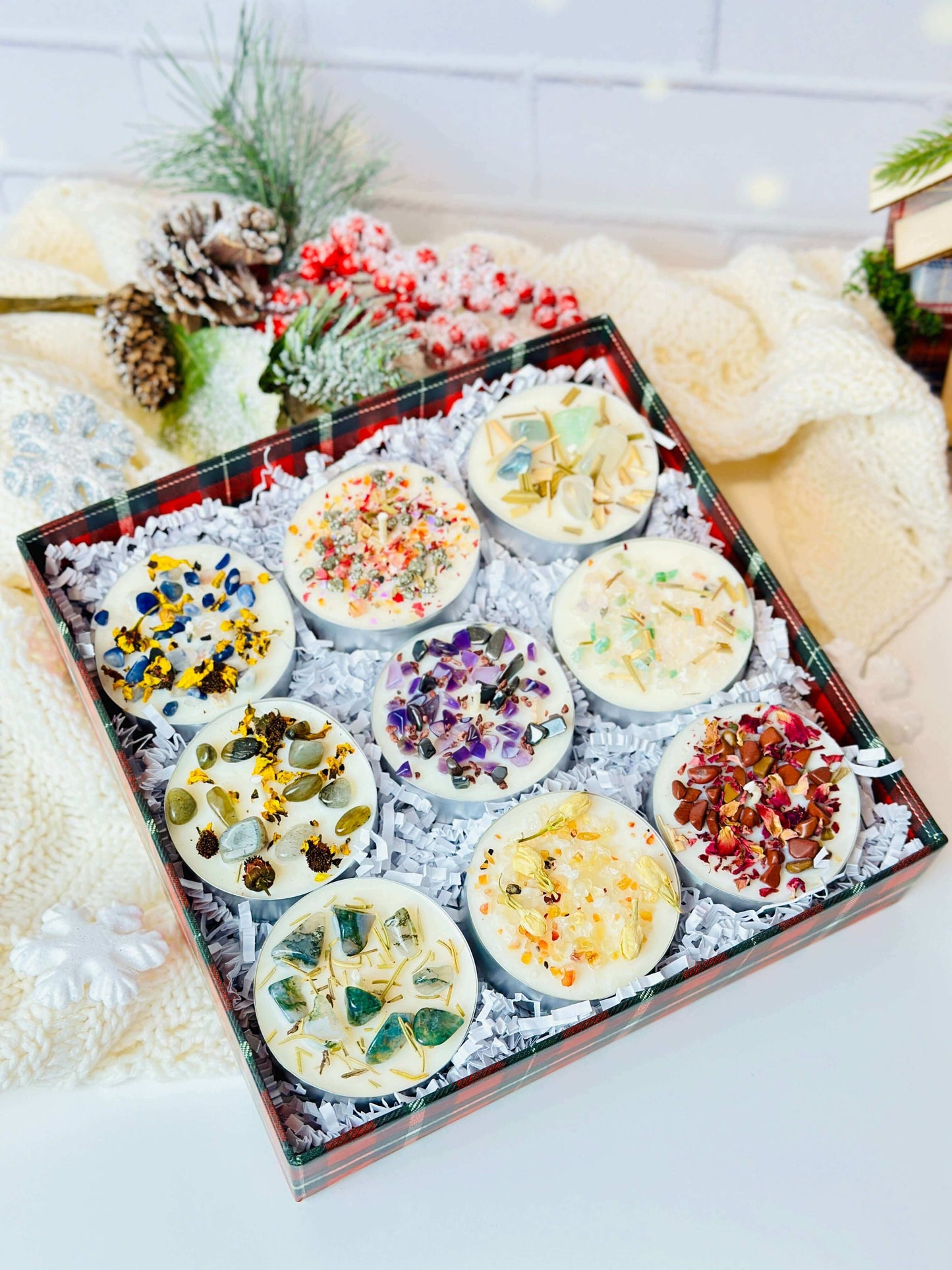Scented tealight candles set displaying 9 beautifully crafted soy wax candles with vibrant herbs and crystals in festive packaging.