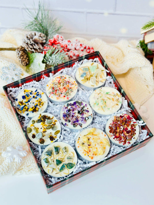Scented tealight candles set displaying 9 beautifully crafted soy wax candles with vibrant herbs and crystals in festive packaging.