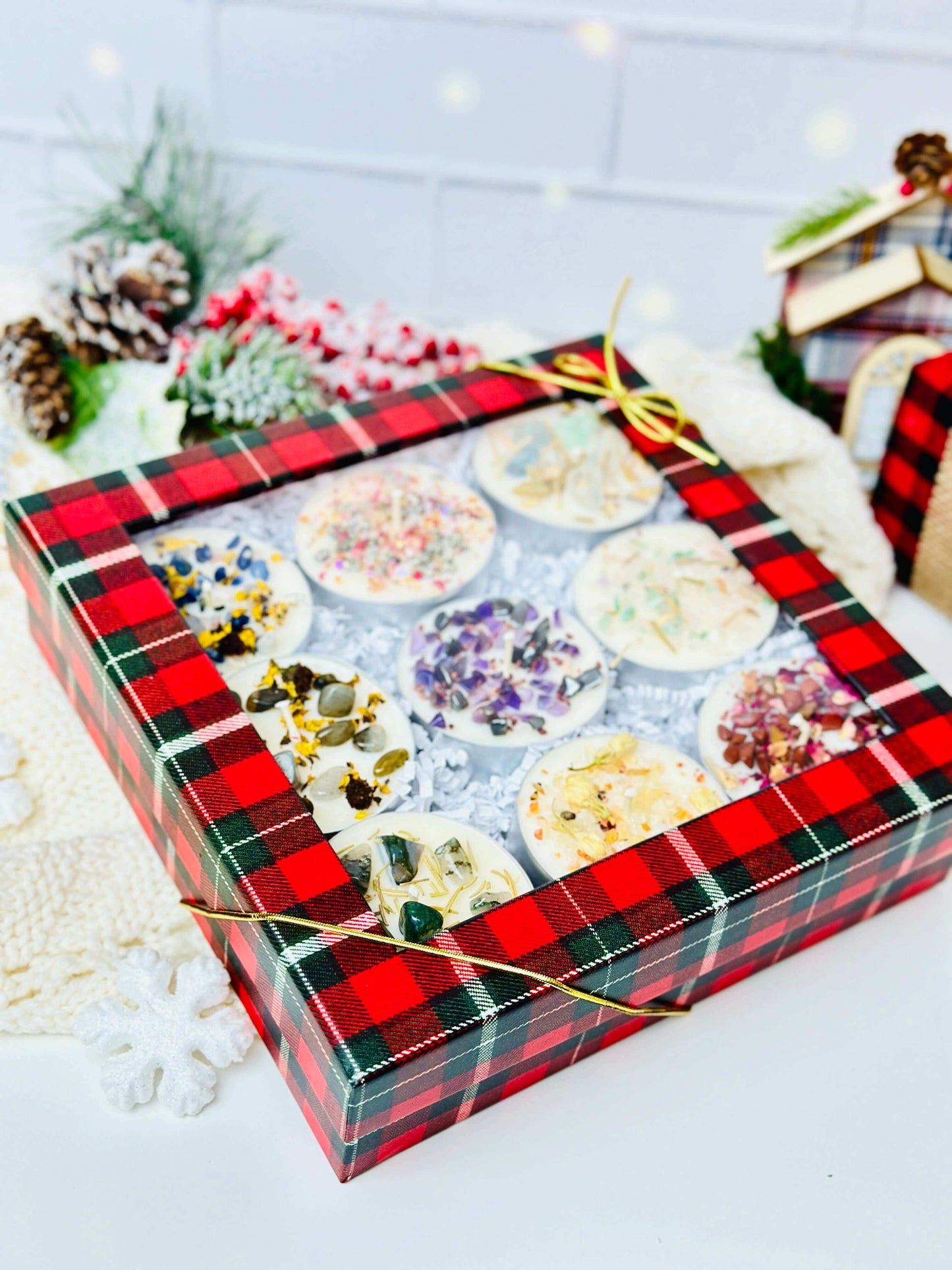 Scented tealight candles set in a decorative box with herbs and crystals, perfect for holiday ambiance.