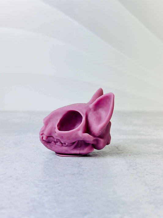 Cat skull silicone mold in purple, perfect for candle making and Halloween decor.