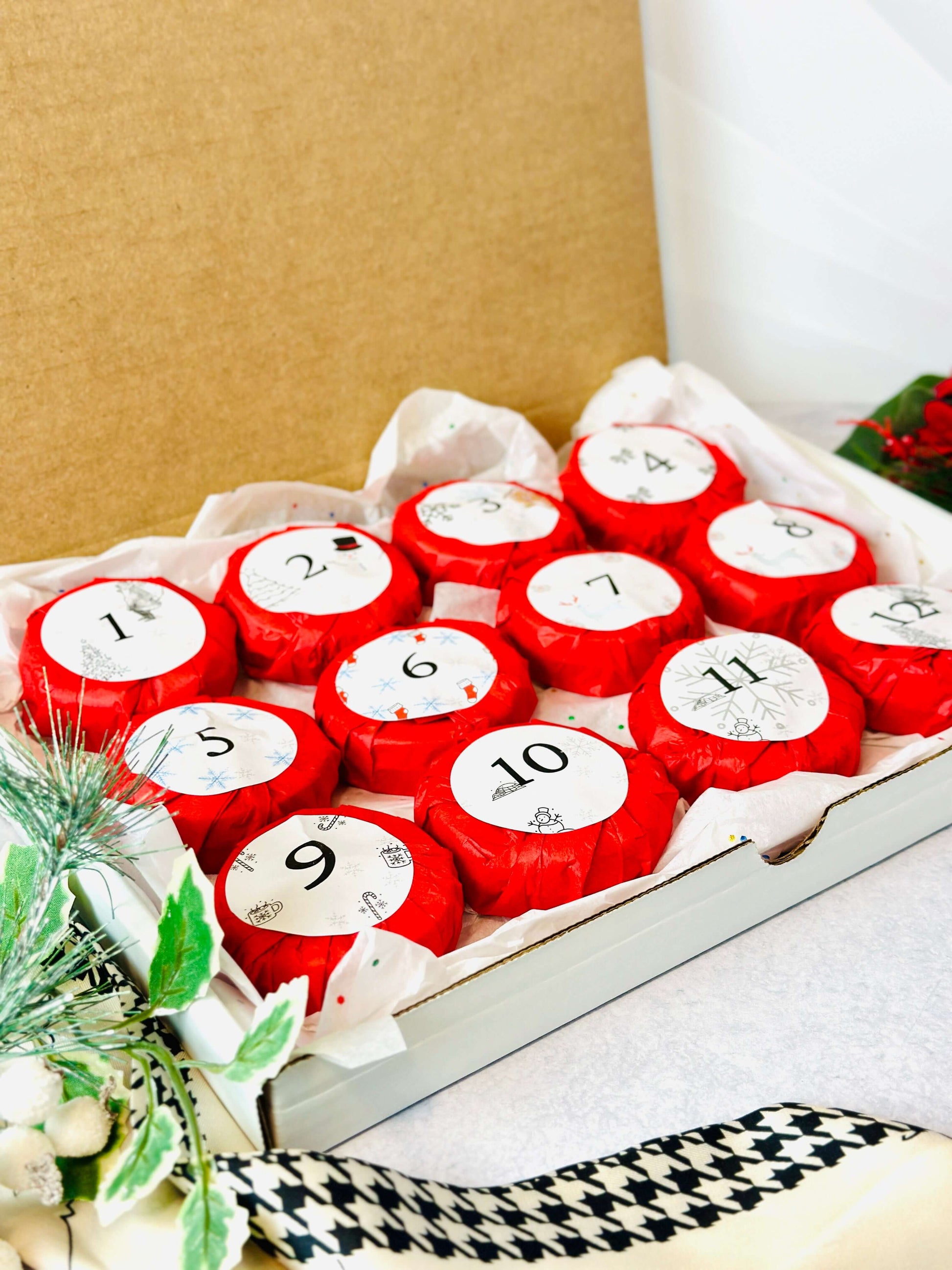 Bookish Candles Advent Calendar 2025 with 12 red wrapped candles in a gift box for Christmas.