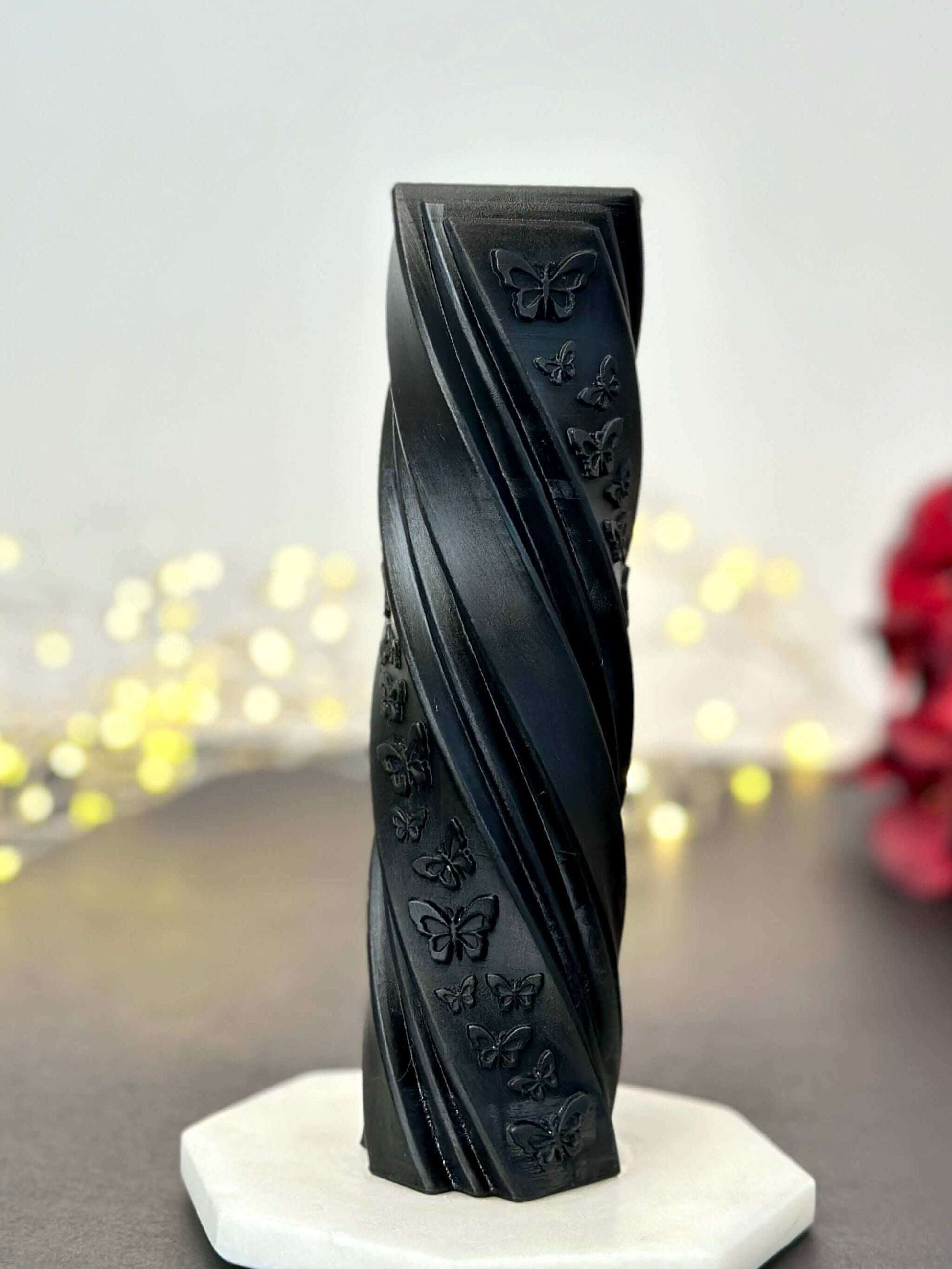 Butterfly pillar candle mold creating a vibrant  pillar candle with butterfly designs and decorative flowers.