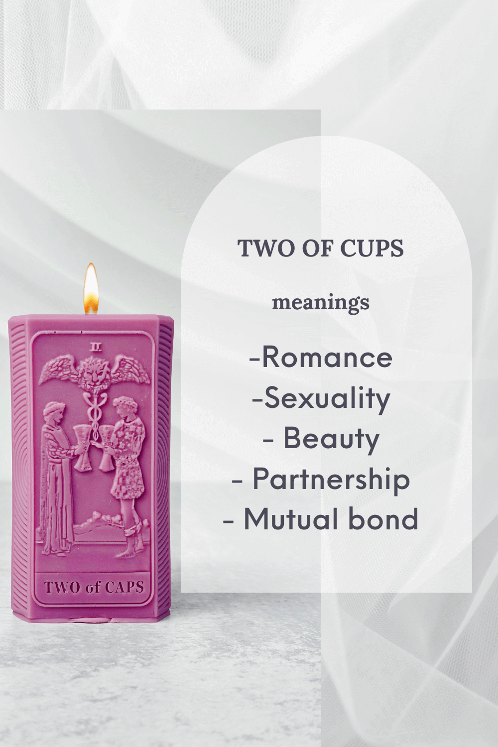 Two of Cups tarot card candle in pink listing meanings like romance, partnership, and mutual bond on a soft background.