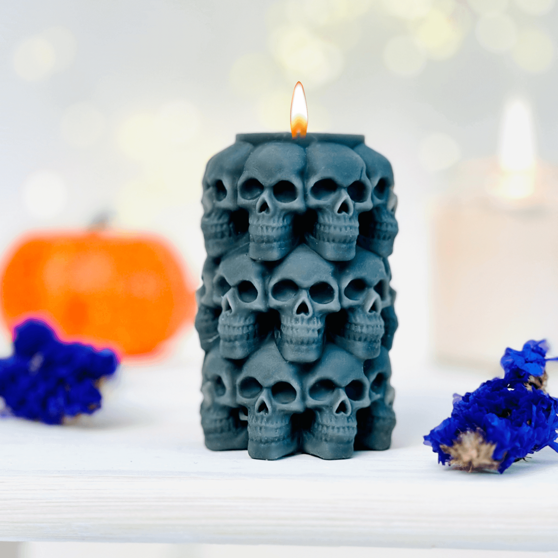 Skulls candle mold used to create a black candle featuring stacked skulls, perfect for Halloween and Day of the Dead.
