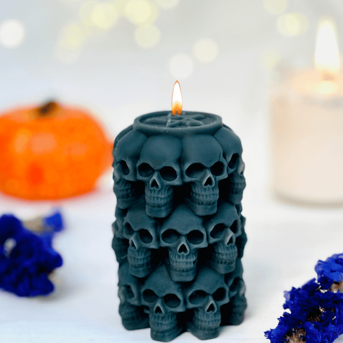 Skulls candle mold used to create a black candle featuring stacked skulls, perfect for Halloween and Day of the Dead.