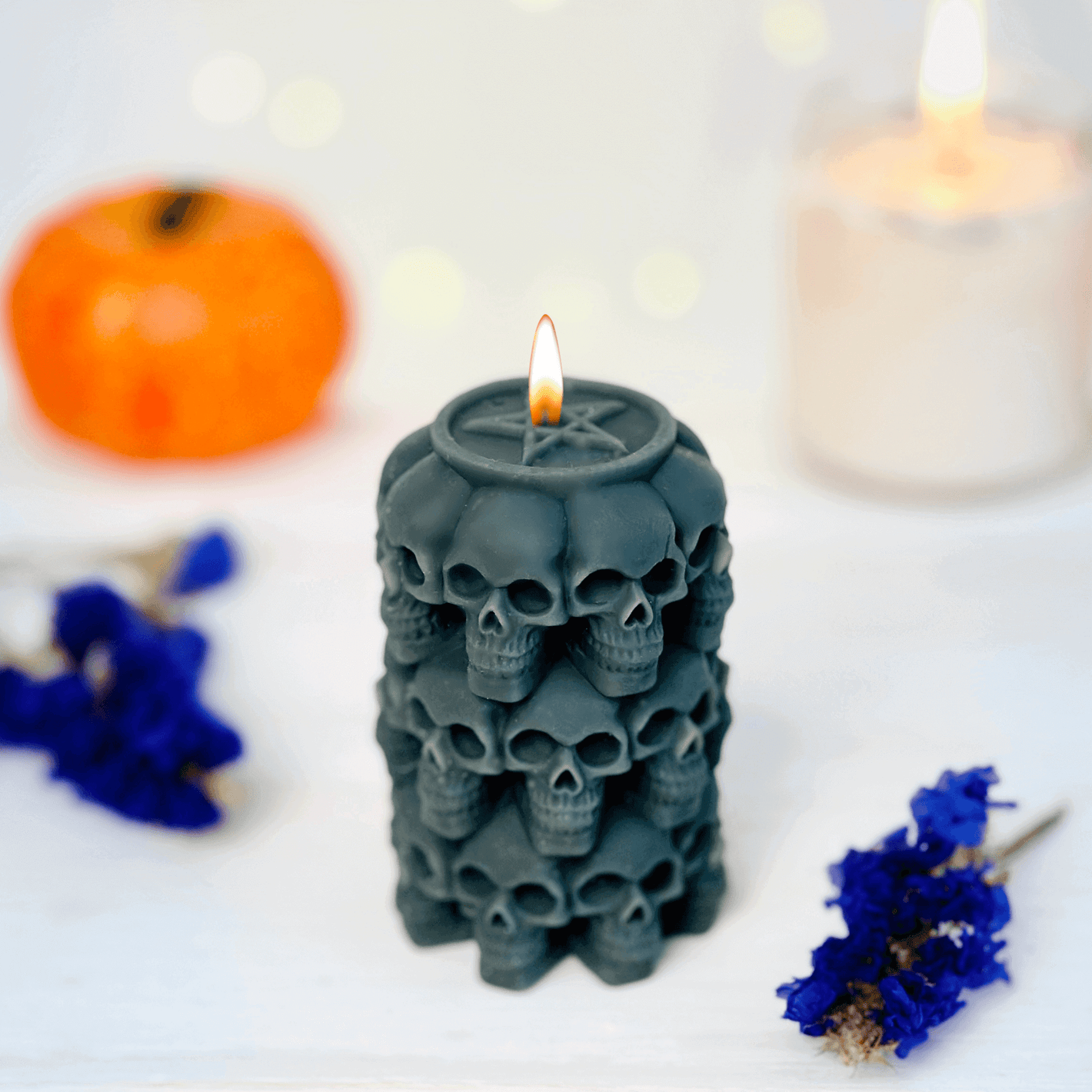 Skulls candle mold used to create a black candle featuring stacked skulls, perfect for Halloween and Day of the Dead.