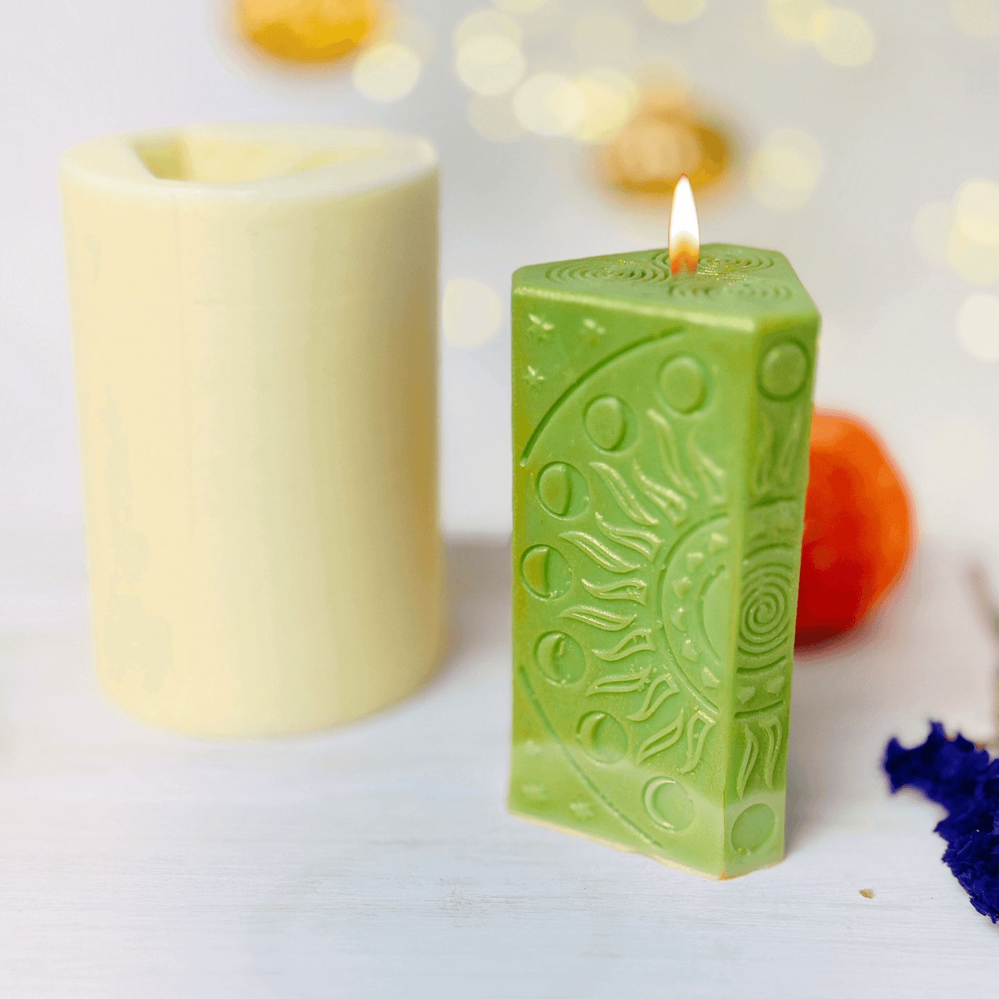 Hanged Man tarot card candle mold displayed with autumn decorations and glowing candlelight.