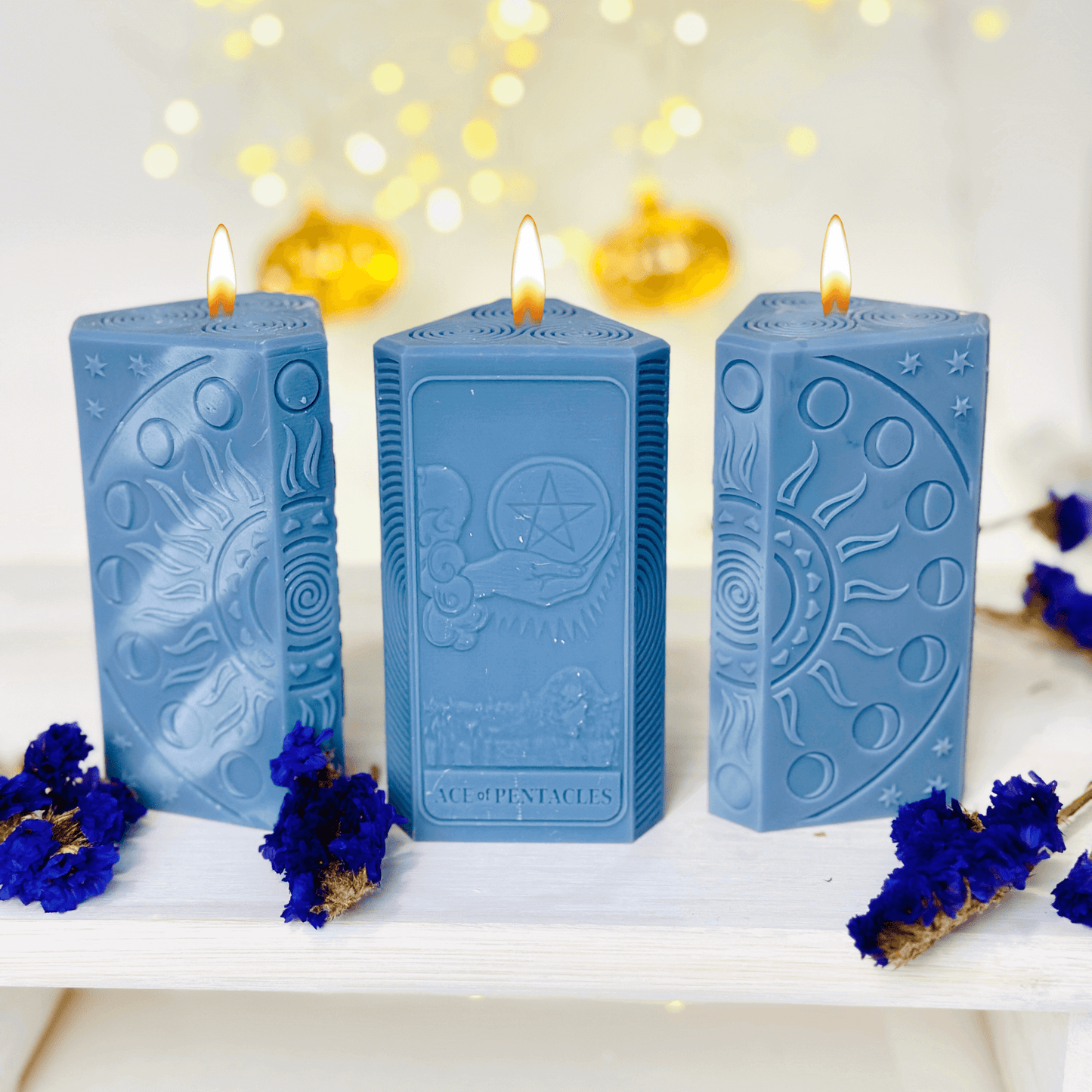 Ace of Pentacles Candle Mold - three blue spiritual candles showcasing sun and moon designs.