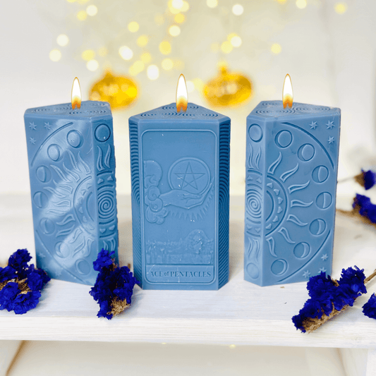 Ace of Pentacles Candle Mold - three blue spiritual candles showcasing sun and moon designs.
