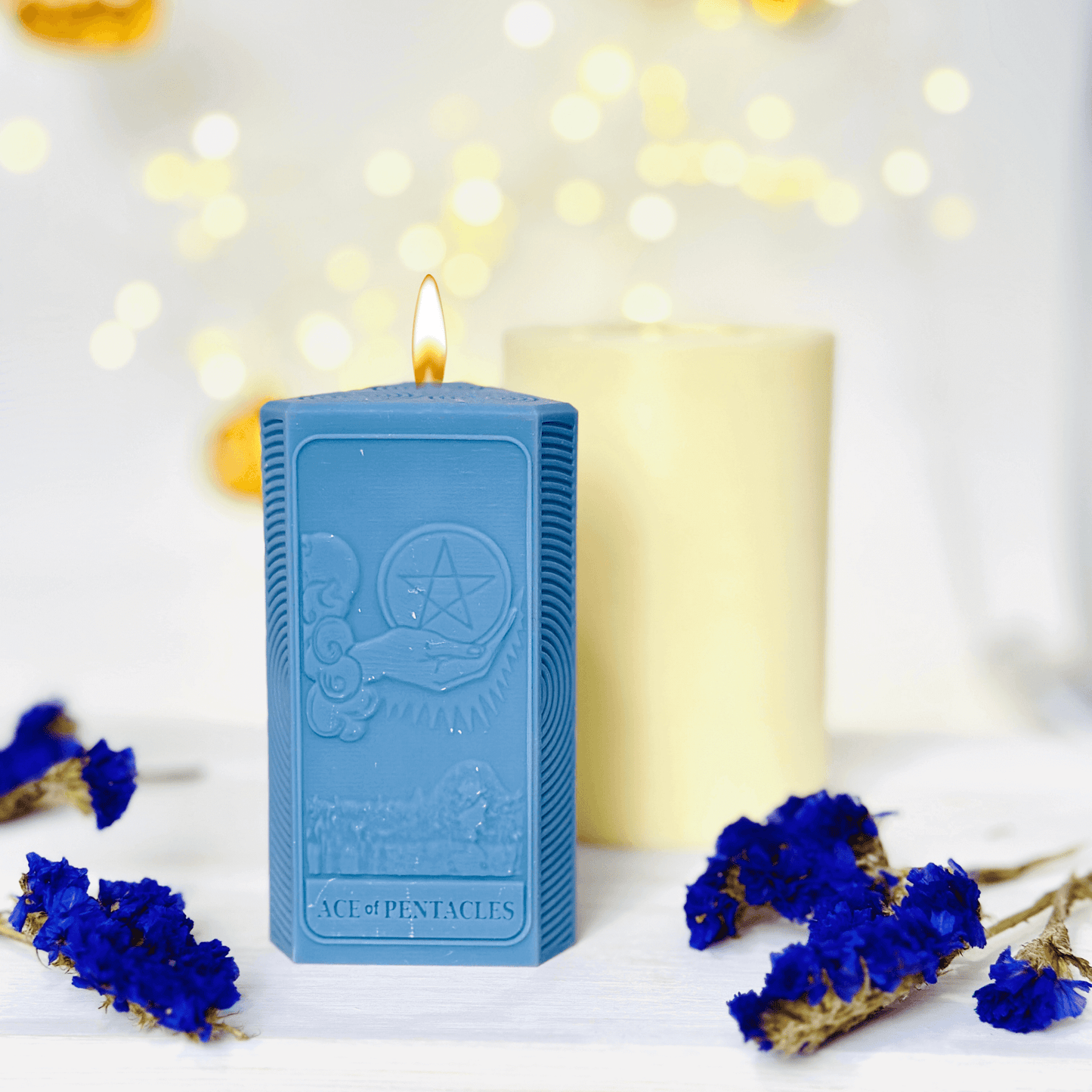 Ace of Pentacles Candle Mold - three blue spiritual candles showcasing sun and moon designs.