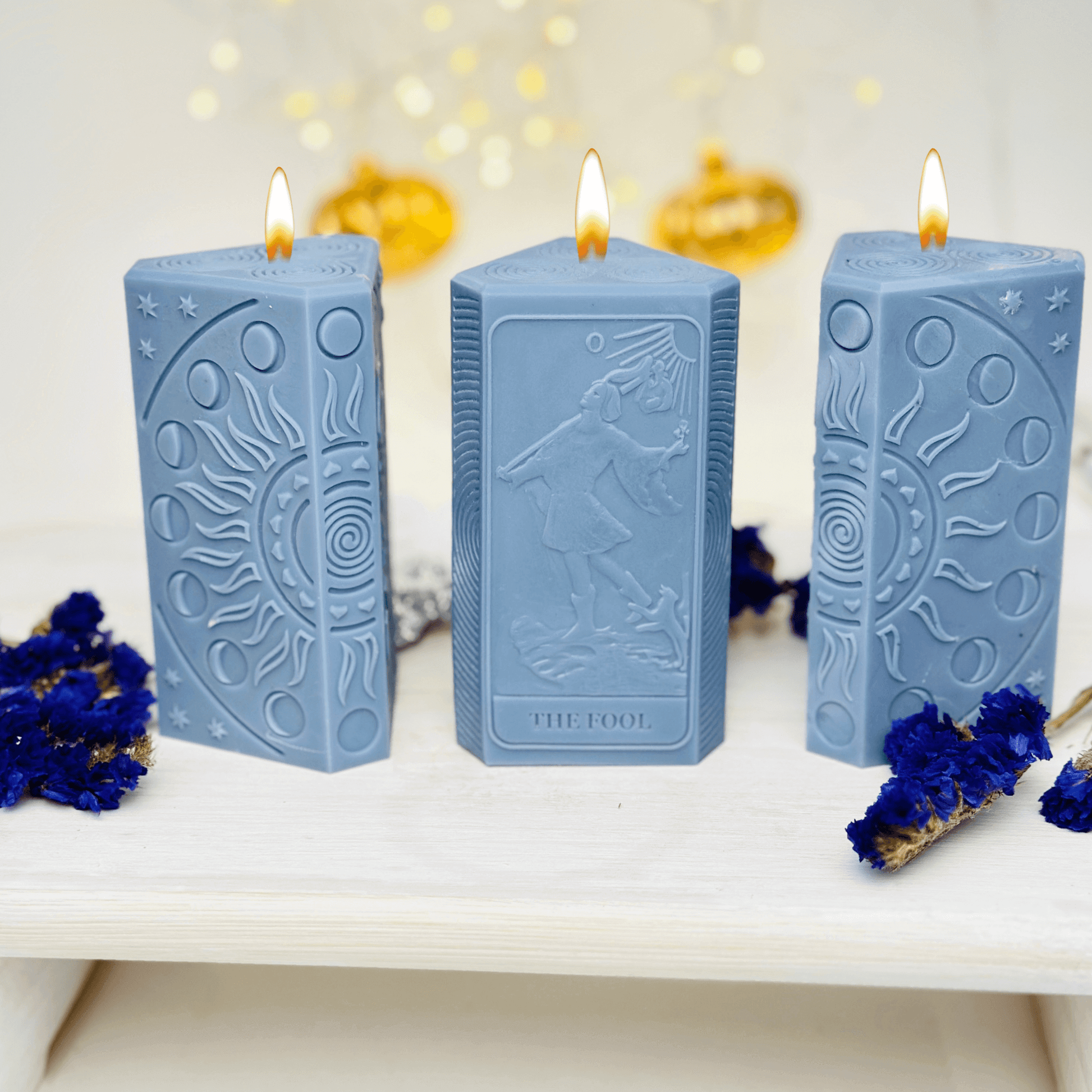 Blue candles featuring The Fool tarot card and moon phases, crafted with a silicone mold for spiritual practices.