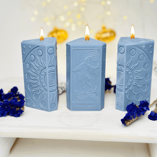 Blue silicone candles shaped like The Fool tarot card and sun phases, perfect for crafting unique spiritual candles.