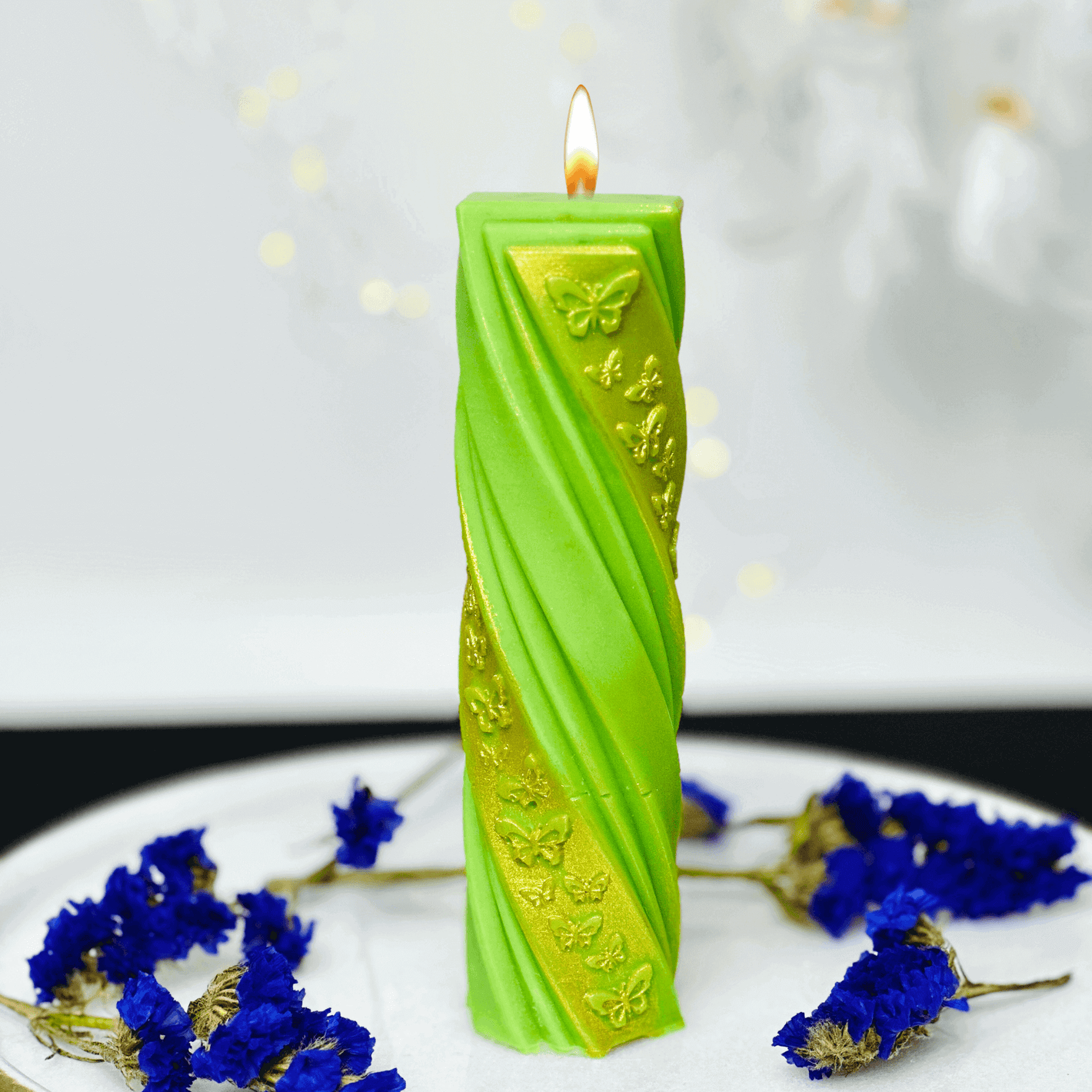 Butterfly pillar candle mold creating a vibrant  pillar candle with butterfly designs and decorative flowers.