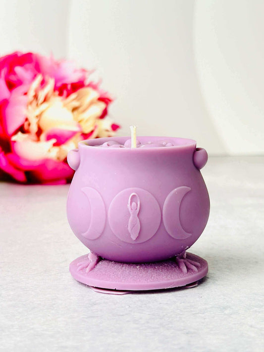 Purple witchcraft cauldron candle made from silicone, featuring intricate designs and a candle wick.