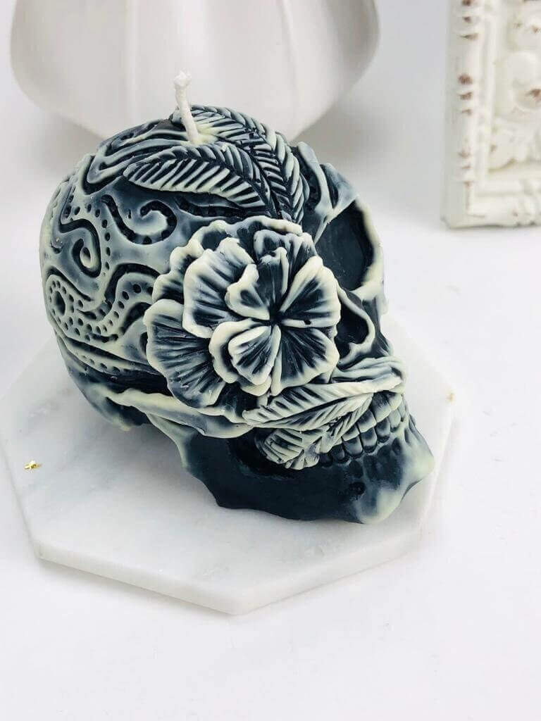 Gothic skull candle with floral designs, perfect for Halloween decor. Durable silicone mold essential for intricate candle crafting.