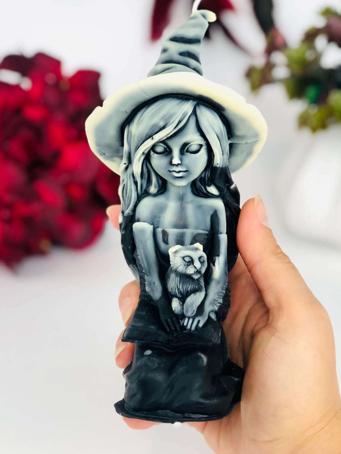 Witch candle with black cat and spell book