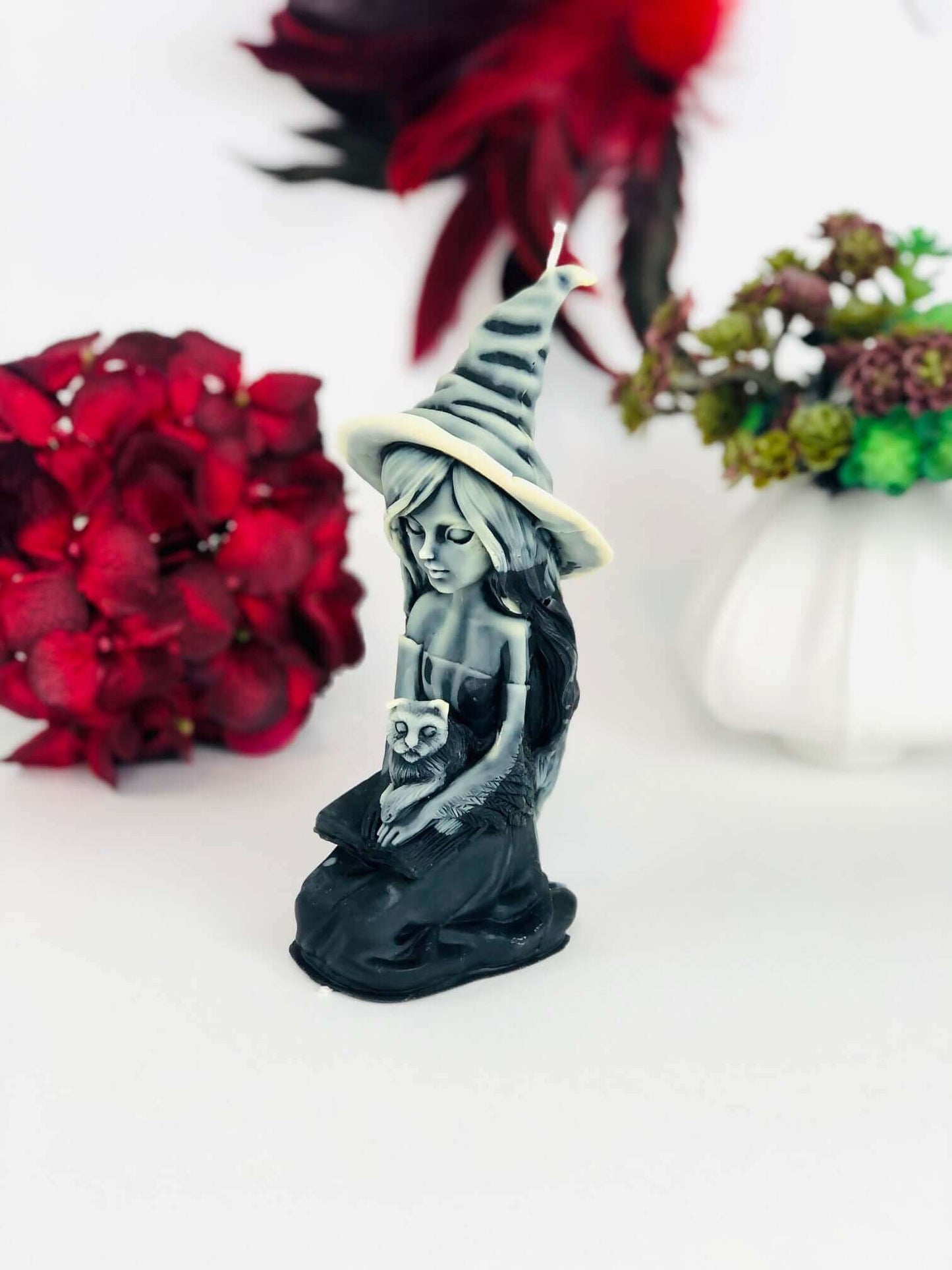Witch candle with black cat and spell book