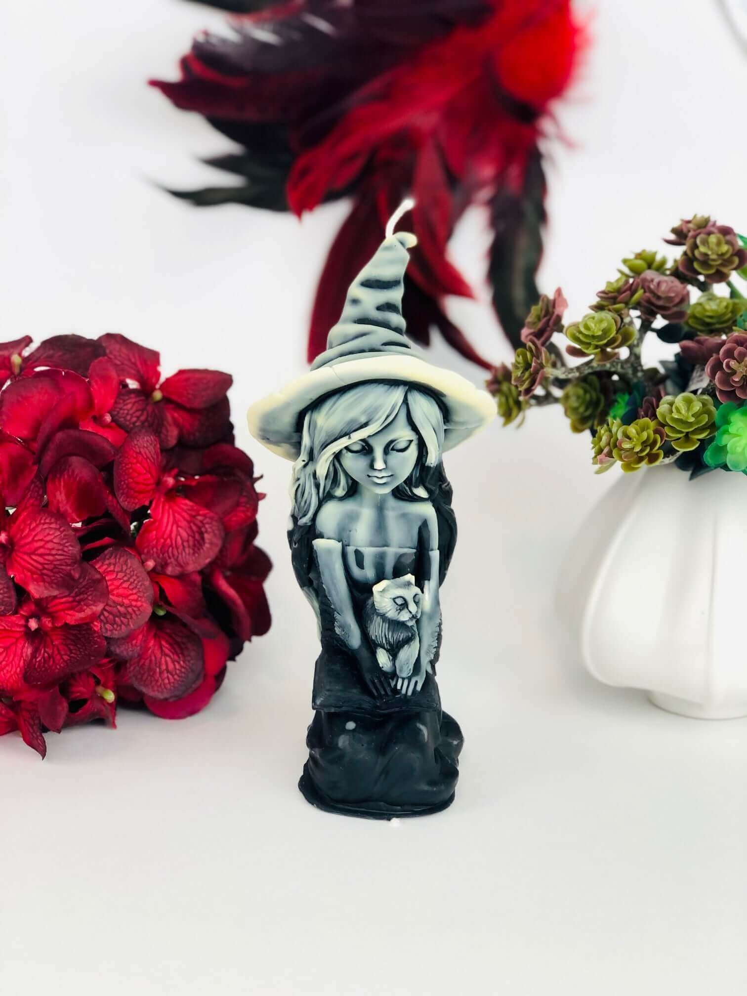 Witch candle with black cat and spell book
