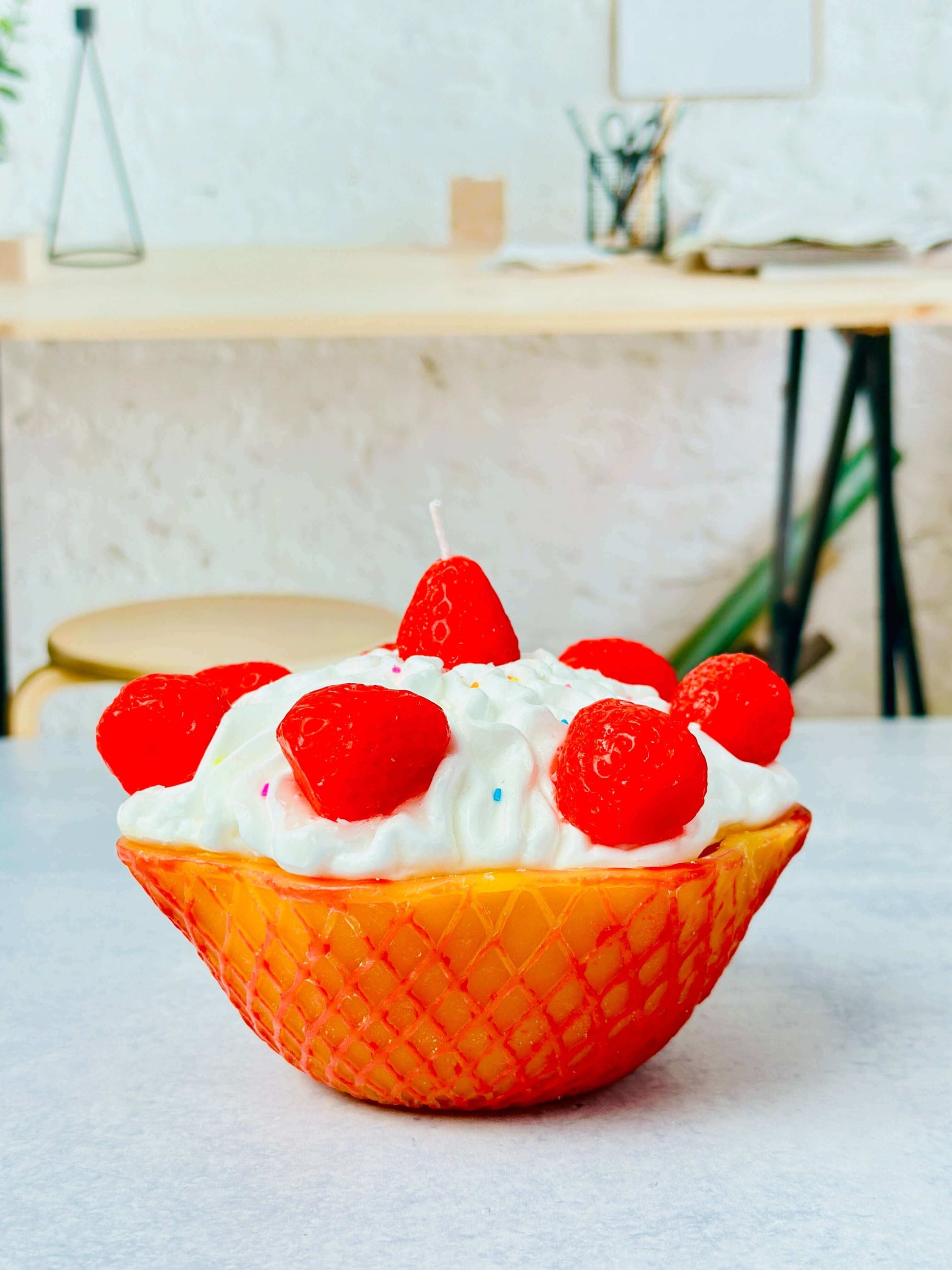 Decorative candle with strawberry design, made using a silicone mold, highlighting its intricate detailing and appealing look