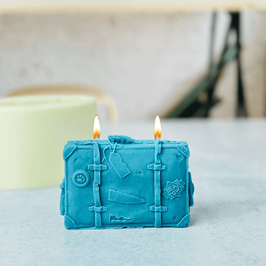 Handcrafted suitcase candle made using a silicone mold